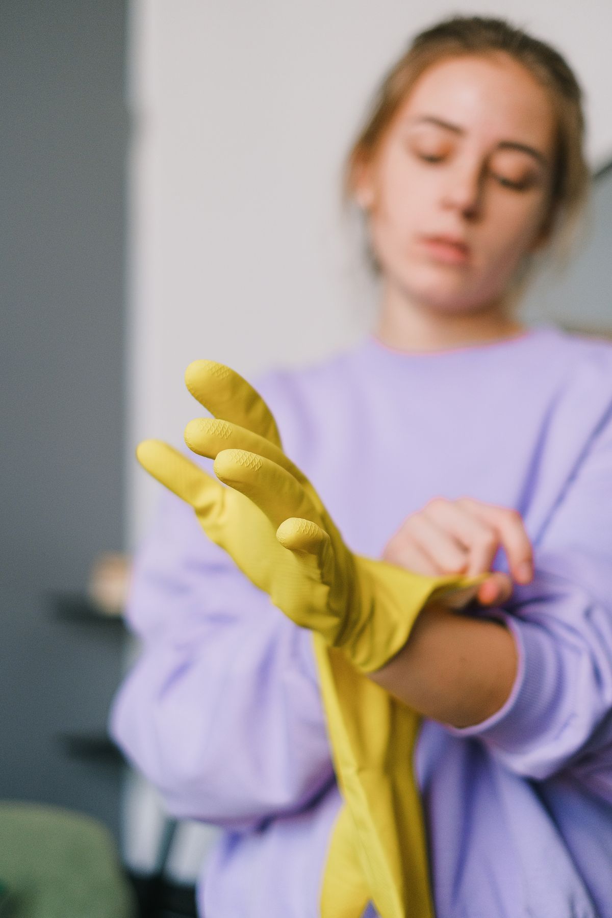 Professional cleaner putting on gloves before a home cleaning