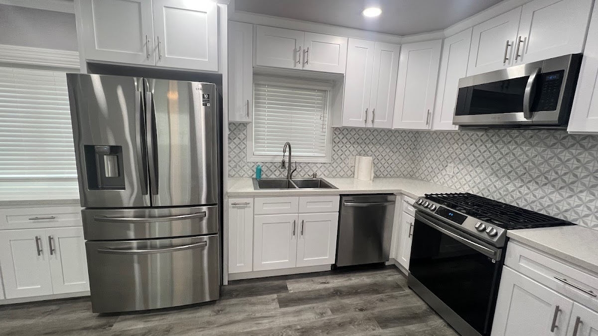 Spotless white kitchen with stainless appliances after a Crystal West deep clean